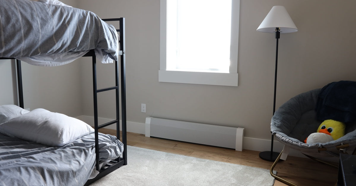 A bedroom with a bunk bed, floor lamp, corner chair, and a baseboard heater on the wall under a window.